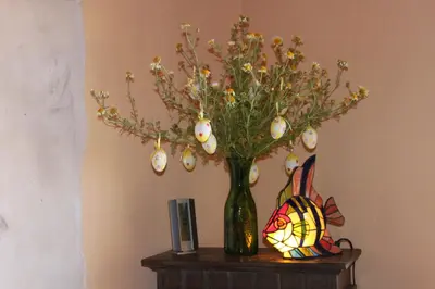 a vase with easter eggs and flowers on a table at Comfortable House near Chania in Kalathas