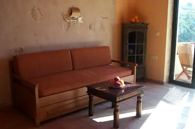 a living room with a couch and a table at Comfortable House near Chania in Kalathas