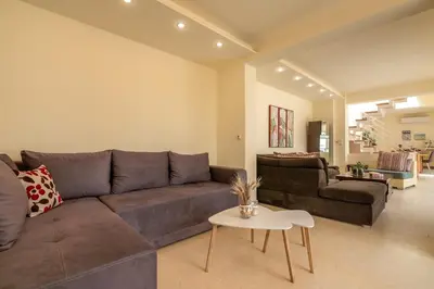 a living room with a couch and a table at Luxury Maisonette in Chania Town