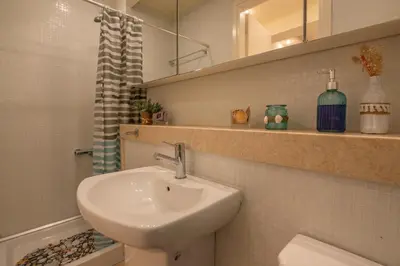 a bathroom with a sink and a toilet and a mirror at Luxury Maisonette in Chania Town