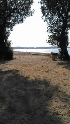 a picnic table on a beach near the water at Luxury Maisonette in Chania Town