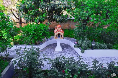 a garden with a small house in the middle at Chania Lissosaparments in Kato Daratso