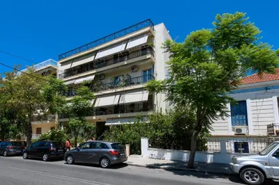 an apartment building with cars parked in front of it at Aspasias Luxury Suite in Chania Town