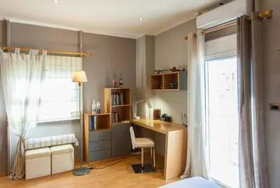 a bedroom with a desk and a bed and a window at Sea view maisonette in Chania Town