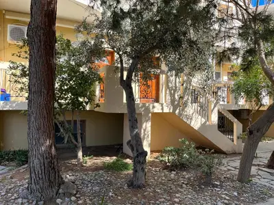 a building with trees in front of it at Mediterranean Sea Down Floor in Palaiochóra