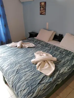 a bed with two towels sitting on top of it at Smaragdi in Chania Town