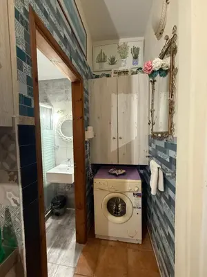 a bathroom with a washing machine and a sink at Modern 1-bedroom with BBQ & Roof Garden near Beach in Stalos