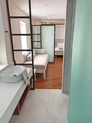 a bathroom with a sink and a bed in a room at Hotel Amphora in Chania Town