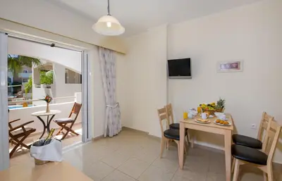 a kitchen and dining room with a table and chairs at Toxo Hotel in Plataniás
