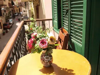 a vase of flowers sitting on a table on a balcony at Anastasia Apartments in Chania Town