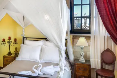 a bedroom with a bed with two swans on it at Casa Leone Hotel in Chania Town