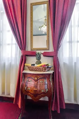a table in a room with curtains and a mirror at Casa Leone Hotel in Chania Town