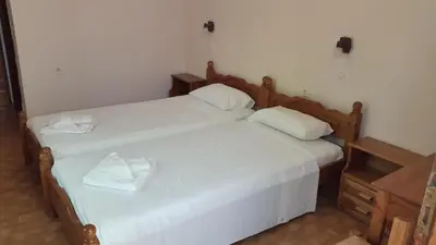 two beds sitting next to each other in a bedroom at Stelios Rooms in Palaiochóra