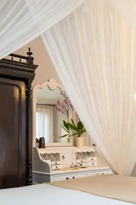 a bedroom with a bed and a mirror at Santa Elena Boutique Rooms in Chania Town