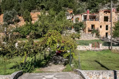 a house on a hill with a garden in front of it at Ifigenia Theriso Village in Thérison