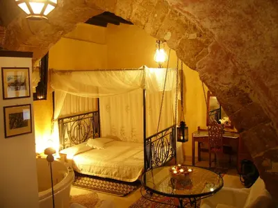 a bedroom with a bed and a glass table at Ifigenia Traditional Rooms & Maisonettes in Chania Town