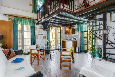 a living room with a table and chairs at Ifigenia by Captain Michalis in Chania Town