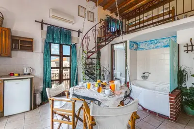 a kitchen with a table and a tub in a bathroom at Ifigenia by Captain Michalis in Chania Town