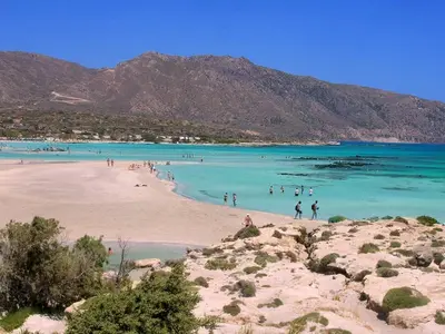 a group of people in the water at a beach at Marelen Apartment Near Chania Center in Chania Town