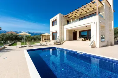 a villa with a swimming pool and a house at Rodi Stone Villa in Kalyves