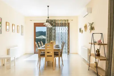 a dining room with a table and chairs at Rodi Stone Villa in Kalyves