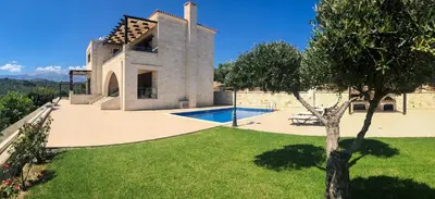 an external view of a villa with a swimming pool at Levanda Luxury Stone Villa in Kalyves