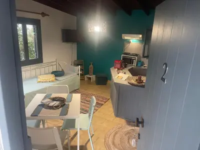 a room with a kitchen and a living room with a table at Villas Vista Del Mar in Kissamos