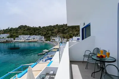 a balcony with a view of the water at Kyma in Loutro