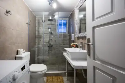 a bathroom with a shower and a toilet and a sink at EvaEle Luxury Boutique in Kissamos