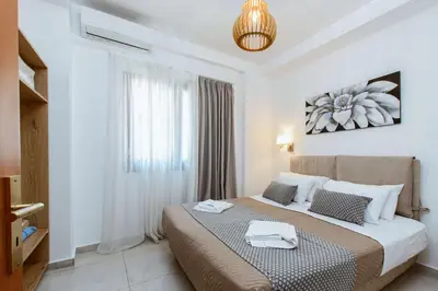 a bedroom with a bed with two towels on it at Deluxe Suites in Chania Town