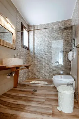 a bathroom with a sink and a tub and a toilet at Deluxe Suites in Chania Town
