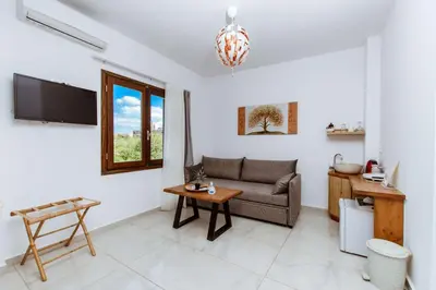 a living room with a couch and a table at Deluxe Suites in Chania Town