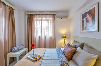 a living room with a couch and a table at Agrimia Holiday Apartments in Plataniás