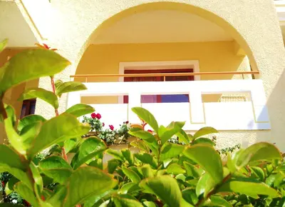 a house with an archway and plants in front of it at Agrimia Holiday Apartments in Plataniás