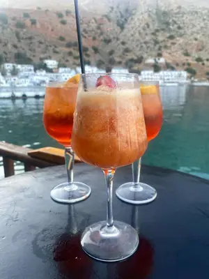 a couple of glasses sitting on top of a table at Sifis in Loutro