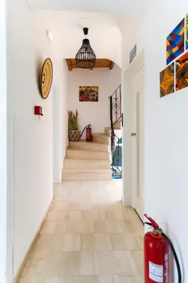a hallway with white walls and a staircase with wood floors at Kumba At Koum Kapi in Chania Town
