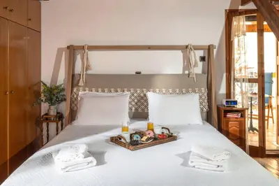a bed with towels and a tray of food on it at Revellino del Porto, Historic Residence in Chania Town