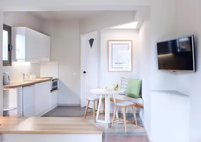 a small kitchen with a table and chairs in a room at Villa Pefki in Chania Town