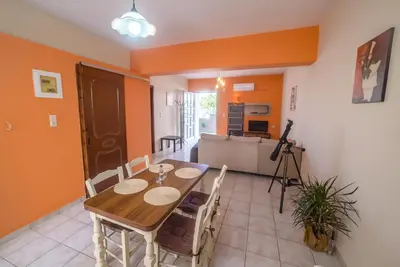 a dining room with a wooden table and chairs at Mamis Studio in Kissamos