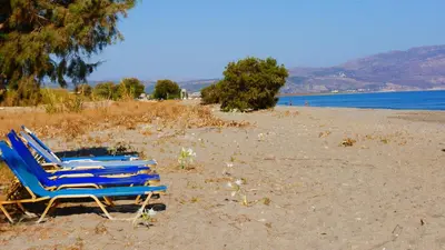 two blue lounge chairs sitting on a beach at Stavros Villas&Apartments in Gerani Chanion