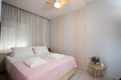 a bedroom with a bed with two towels on it at NK Apartments in Falasarna