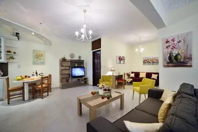 a living room with a couch and a table at Aristea's Apartment 1st Floor in Chania Town