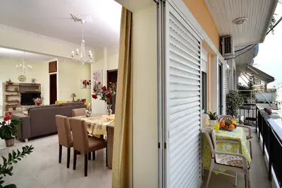 a dining room and kitchen with a table and chairs at Aristea's Apartment 1st Floor in Chania Town