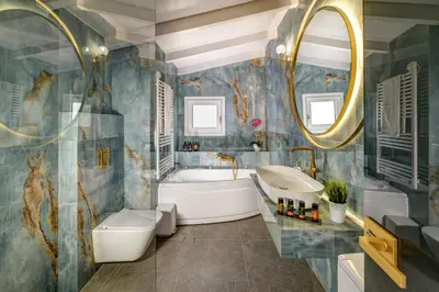 a bathroom with a tub and a sink and a mirror at Casa Veneziana in Chania Town