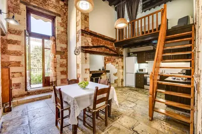 a kitchen with a table and chairs in a room at Casa Veneziana in Chania Town
