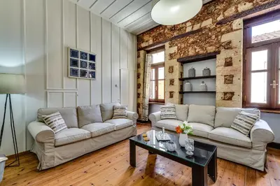 a living room with two couches and a table at Casa Veneziana in Chania Town