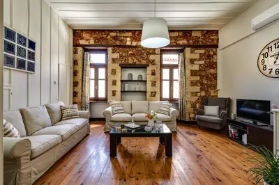 a living room with a couch and a table at Casa Veneziana in Chania Town