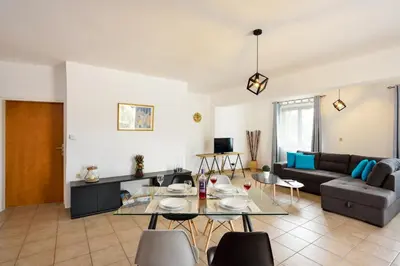 a living room with a couch and a table at Feels like home in Chania Town