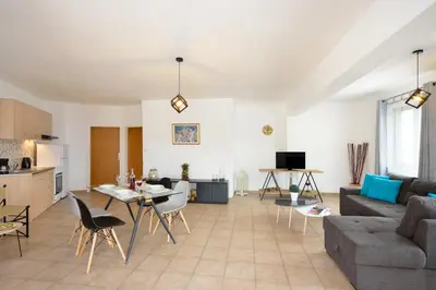 a living room with a couch and a table at Feels like home in Chania Town