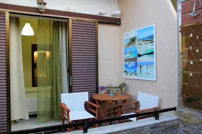 a patio with a table and chairs on a balcony at Your Home in Kato Daratso